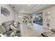 Open living room featuring comfortable seating, modern decor, and access to the outdoor pool area at 13951 Wood Duck Cir, Lakewood Ranch, FL 34202