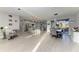 Open-concept living space featuring a dining area and modern kitchen with an island at 13951 Wood Duck Cir, Lakewood Ranch, FL 34202