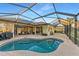 Large screened-in pool with a spacious deck and lake view at 13951 Wood Duck Cir, Lakewood Ranch, FL 34202