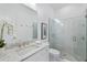 Modern bathroom with white cabinets, granite countertop, and glass-enclosed shower at 15603 Derna Ter, Bradenton, FL 34211