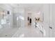 Modern bathroom with walk-in shower, marble floors, and double vanity at 15603 Derna Ter, Bradenton, FL 34211