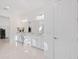 Bright, all-white bathroom with double vanity and access to the closet at 15603 Derna Ter, Bradenton, FL 34211