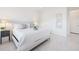 Serene bedroom with neutral walls and furnishings, featuring a view of a hall at 15603 Derna Ter, Bradenton, FL 34211