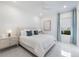 The bedroom features a light interior with modern decor and a view to the backyard at 15603 Derna Ter, Bradenton, FL 34211
