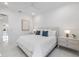 Bright, all-white bedroom with a ceiling fan and modern decor at 15603 Derna Ter, Bradenton, FL 34211
