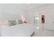 Bright, all-white bedroom with marble floors leading to the bathroom and closet at 15603 Derna Ter, Bradenton, FL 34211
