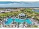 Stunning aerial view of a large community pool with a bar, surrounded by palm trees and lounge chairs at 15603 Derna Ter, Bradenton, FL 34211