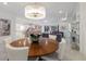 Elegant dining room featuring modern chandelier, wood table, and views into the living space at 15603 Derna Ter, Bradenton, FL 34211