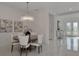 Bright dining room with a large round table and modern chandelier at 15603 Derna Ter, Bradenton, FL 34211