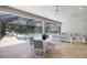 Outdoor patio with covered seating and dining, overlooking screened-in pool and lush landscaping at 15603 Derna Ter, Bradenton, FL 34211