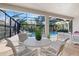 Outdoor dining and living area with screened-in pool in background, perfect for entertaining at 15603 Derna Ter, Bradenton, FL 34211