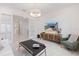 The cozy living room features a modern light fixture and light-colored furniture at 15603 Derna Ter, Bradenton, FL 34211