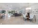 Open-concept living space with dining area, comfortable seating, and access to a screened-in patio at 15603 Derna Ter, Bradenton, FL 34211