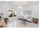 Bright living room features a large window, modern lighting, and neutral furniture at 15603 Derna Ter, Bradenton, FL 34211