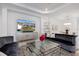 Open concept living room features modern furniture and a large screen television at 15603 Derna Ter, Bradenton, FL 34211