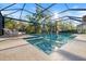 Relaxing screened pool with sun loungers and view of mature trees at 15603 Derna Ter, Bradenton, FL 34211