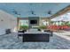 Relaxing outdoor lounge area with comfortable seating and large TV at 15603 Derna Ter, Bradenton, FL 34211