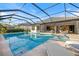 Beautiful backyard pool with covered lanai offering ample seating and open access to the home's interior at 15603 Derna Ter, Bradenton, FL 34211
