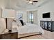 Main bedroom with king-size bed, TV, and water view at 17404 Hickok Belt Loop, Bradenton, FL 34211