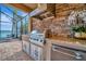 Outdoor kitchen with stainless steel appliances and stone accents at 17404 Hickok Belt Loop, Bradenton, FL 34211