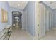 Light blue hallway with tile floors and access to other rooms at 23633 Copperleaf Dr, Venice, FL 34293