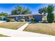 Updated mid-century ranch home with a modern color palette and landscaping at 2374 Conway Blvd, Port Charlotte, FL 33952