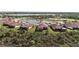 Aerial view of house near lake in residential community at 23964 Skyflower Ct, Venice, FL 34293