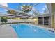 Inviting, refreshing pool with a covered patio area at 305 N Conrad Ave, Sarasota, FL 34237