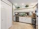 White kitchen cabinets, granite counters, stainless steel appliances at 3215 Woodberry Ln, Sarasota, FL 34231