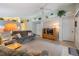 Comfortable living room with neutral decor, built-in shelving, and a view to kitchen at 3215 Woodberry Ln, Sarasota, FL 34231