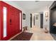 Bright entry with red door, tile floor, and unique decor at 324 Bernard Ave, Sarasota, FL 34243