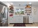 Bright kitchen with white cabinets, stainless steel appliances and a farmhouse sink at 324 Bernard Ave, Sarasota, FL 34243