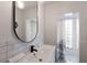 Modern bathroom with a large mirror, white subway tile, and a shower at 3913 Chapel Dr, Sarasota, FL 34234