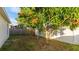 Small backyard with various trees and a white vinyl fence at 4107 11Th E St, Bradenton, FL 34208