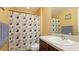 Clean bathroom with shower/tub and geometric shower curtain at 4107 11Th E St, Bradenton, FL 34208