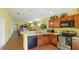 Open concept kitchen with breakfast bar and view into living room at 4107 11Th E St, Bradenton, FL 34208