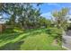 Expansive backyard with grassy lawn, mature trees, and privacy fence at 4132 Carriage Cir # 12, Sarasota, FL 34241