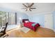 Light blue bedroom with hardwood floors and ceiling fan at 4132 Carriage Cir # 12, Sarasota, FL 34241