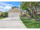 House exterior featuring a white garage door and manicured lawn at 4132 Carriage Cir # 12, Sarasota, FL 34241