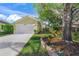 Exterior of a light yellow house with a lush green lawn at 4132 Carriage Cir # 12, Sarasota, FL 34241