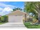 Front view of a yellow house with a white garage door at 4132 Carriage Cir # 12, Sarasota, FL 34241
