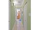 Clean hallway with light green walls and tile floors at 4132 Carriage Cir # 12, Sarasota, FL 34241