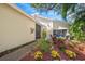 Inviting patio area with seating and colorful landscaping at 4132 Carriage Cir # 12, Sarasota, FL 34241