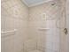 Walk-in shower with tiled walls and built-in seat at 4132 Carriage Cir # 12, Sarasota, FL 34241