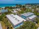 Aerial view of community featuring a blue building, a pool, and beach views at 4307 Gulf Dr # 103, Holmes Beach, FL 34217