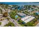 Aerial view of community featuring a blue building, a pool, and waterfront views at 4307 Gulf Dr # 103, Holmes Beach, FL 34217