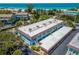 Coastal condo building featuring a covered parking area with beach access at 4307 Gulf Dr # 103, Holmes Beach, FL 34217