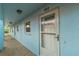 Exterior view of building showing light blue walls and a white door at 4307 Gulf Dr # 103, Holmes Beach, FL 34217