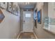 Bright entryway with white door, hardwood floors, and beach-themed decor at 4307 Gulf Dr # 103, Holmes Beach, FL 34217