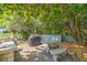 Community grill area with seating surrounded by lush, tropical landscaping at 4307 Gulf Dr # 103, Holmes Beach, FL 34217